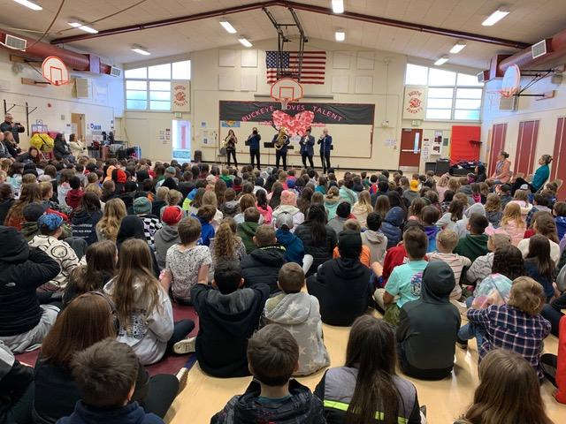 musicians performing at elementary school assembly