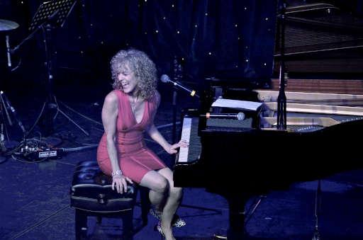 Judy Carmichael at piano, laughing